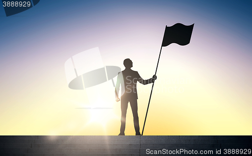 Image of silhouette of businessman with flag over sun light