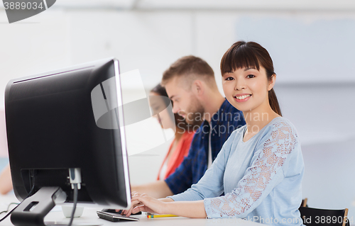 Image of happy creative team or students working at office