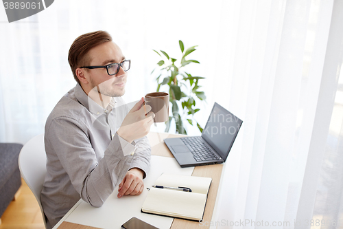 Image of creative man or businessman drinking coffee