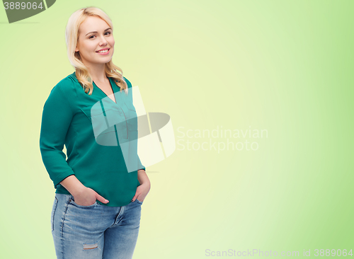 Image of smiling young woman in shirt and jeans