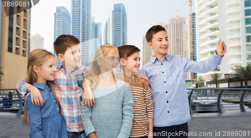Image of happy children talking selfie by smartphone