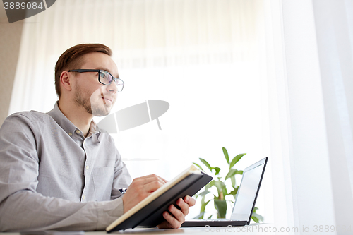 Image of creative male worker or businessman with notebook