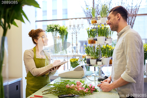 Image of florist woman and man making order at flower shop