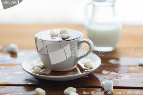 Image of close up of sugar in coffee cup on wooden table