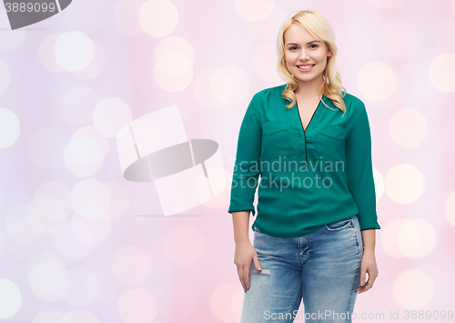 Image of smiling young woman in shirt and jeans