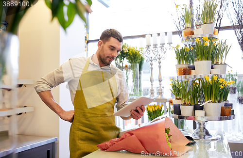 Image of man with tablet pc computer at flower shop