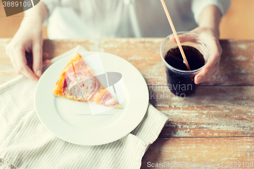Image of close up of woman with pizza and coca cola drink