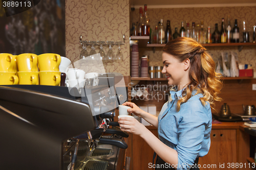 Image of barista woman making coffee by machine at cafe