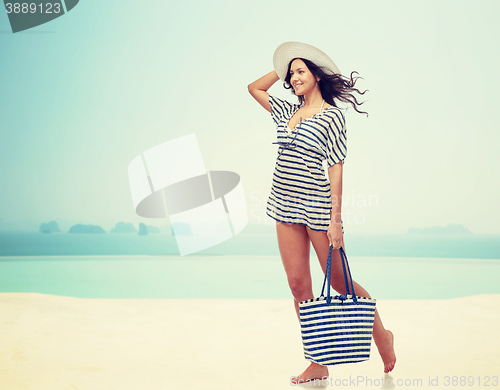 Image of happy young woman in summer clothes and sun hat