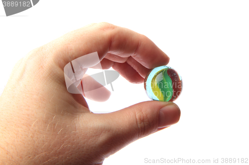 Image of color glass sphere in the human hand