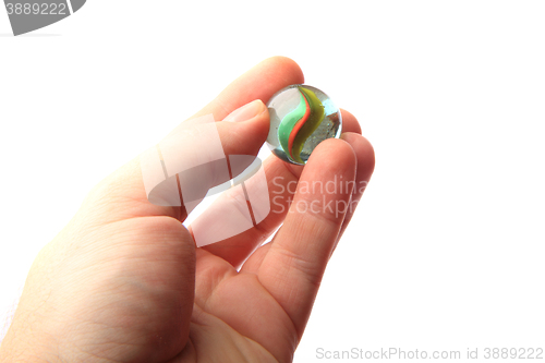 Image of color glass sphere in the human hand