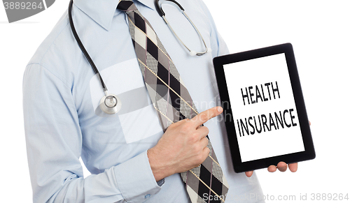 Image of Doctor holding tablet - Health insurance