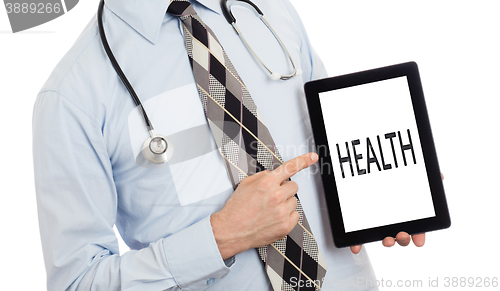 Image of Doctor holding tablet - Health