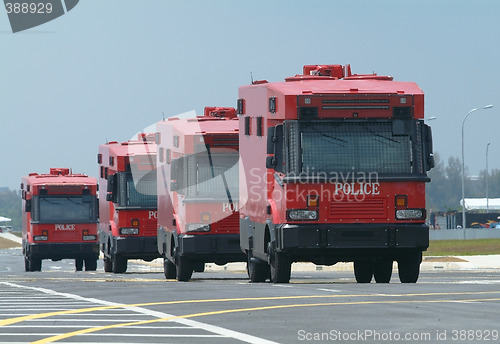 Image of Four red police trucks