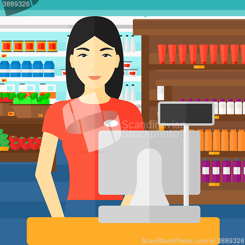 Image of Saleslady standing at checkout.