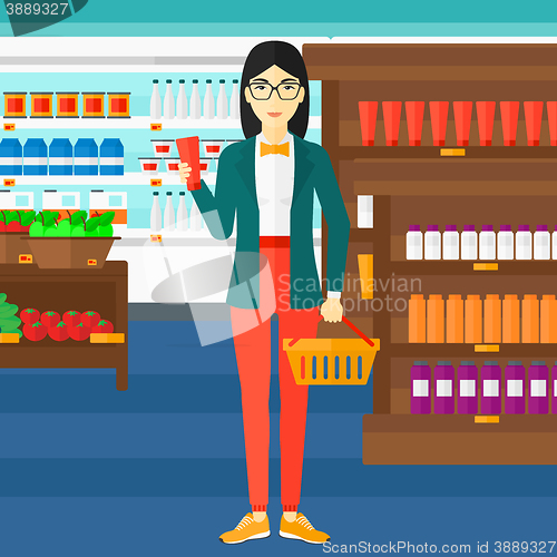 Image of Customer with shopping basket and tube of cream.