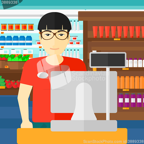 Image of Salesman standing  at checkout.