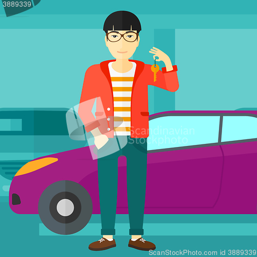 Image of Man holding keys from new car.