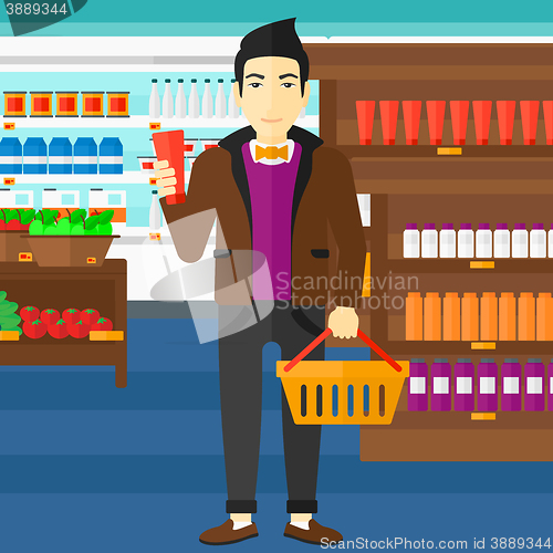 Image of Customer with shopping basket and tube of cream.