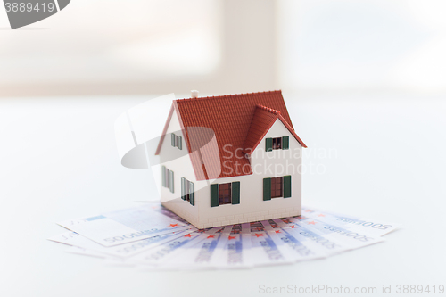 Image of close up of home or house model and money