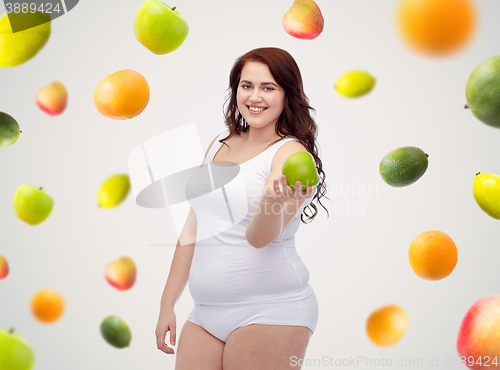 Image of happy plus size woman in underwear with apple