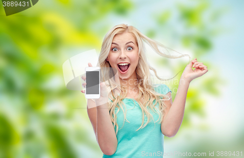 Image of happy young woman or teenage girl with smartphone