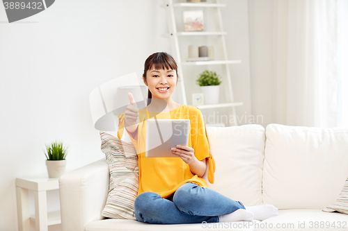 Image of happy asian woman with tablet pc and thumbs up
