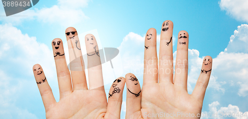 Image of close up of hands and fingers with smiley faces