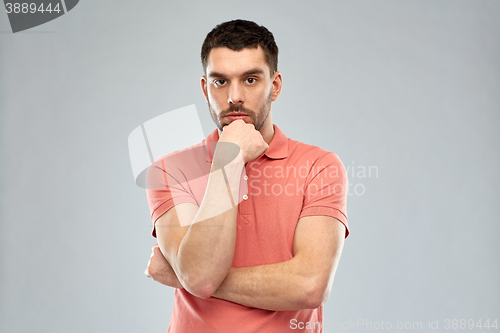 Image of man thinking over gray background