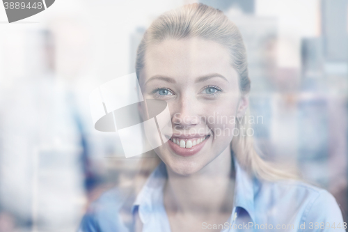 Image of group of smiling businesspeople meeting in office