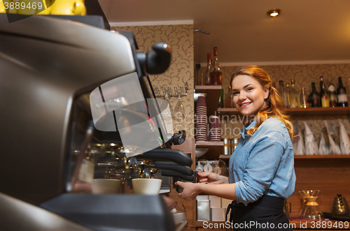 Image of barista woman making coffee by machine at cafe