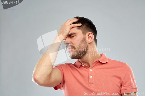 Image of unhappy man suffering from head ache