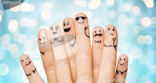 Image of close up of hands and fingers with smiley faces