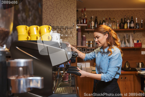 Image of barista woman making coffee by machine at cafe