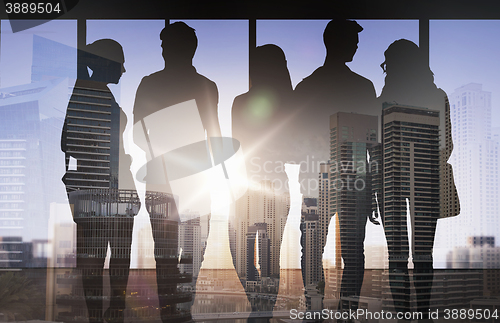 Image of people silhouettes over city background