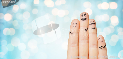 Image of close up of hands and fingers with smiley faces