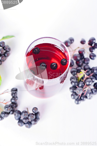 Image of Glass of aronia juice with berries, overhead view