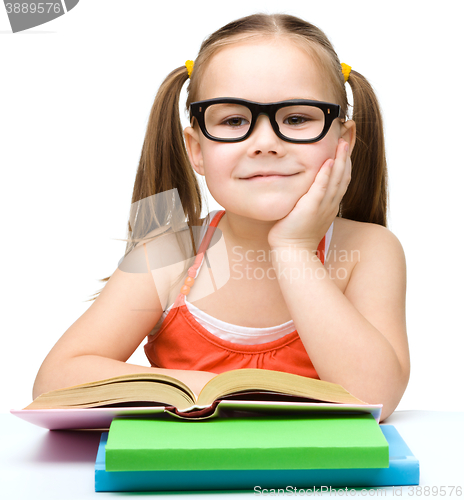 Image of Little girl is reading a book