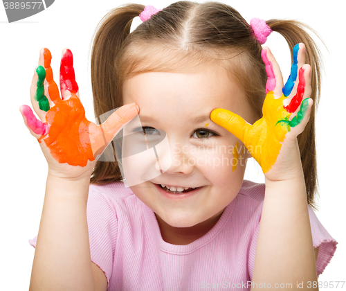 Image of Portrait of a cute girl playing with paints