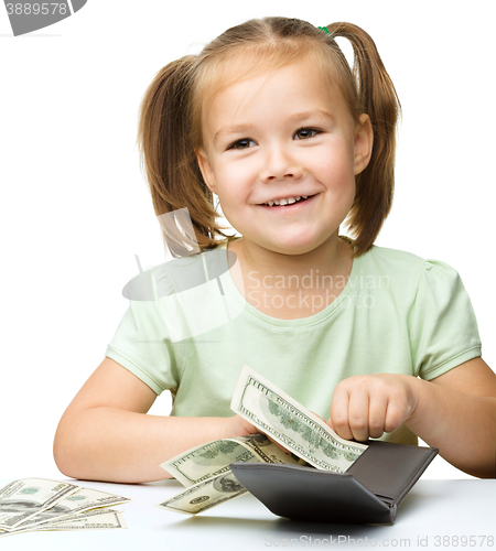 Image of Little girl is counting dollars