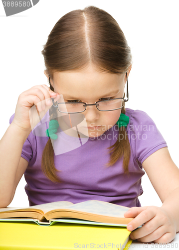 Image of Little girl is reading a book