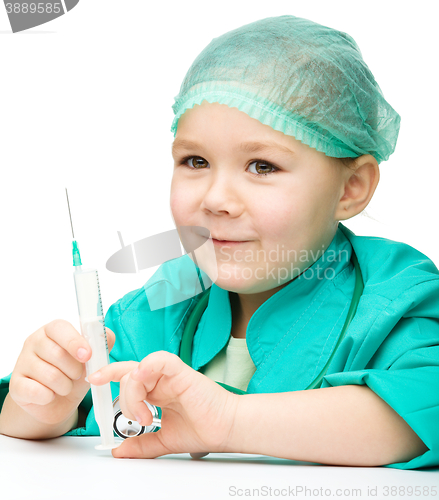 Image of Cute little girl is playing doctor with syringe