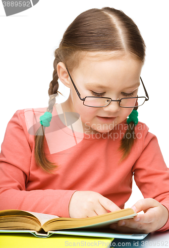 Image of Little girl is reading a book