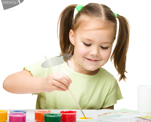 Image of Cute cheerful child play with paints