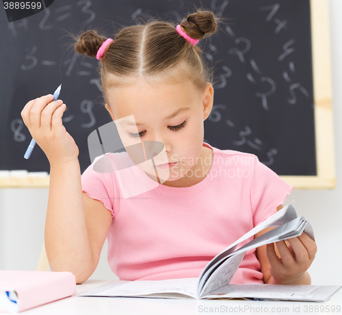 Image of Little girl is studying