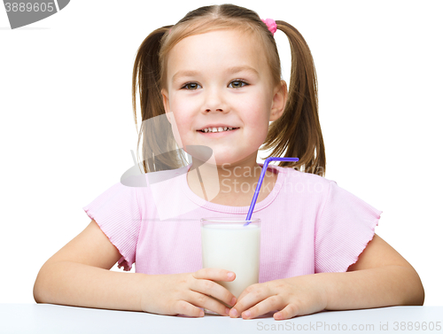 Image of Cute little girl with a glass of milk