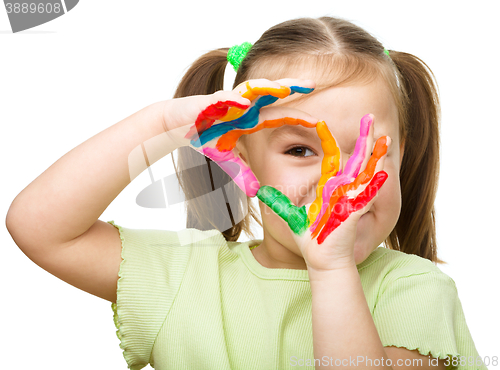 Image of Portrait of a cute girl playing with paints