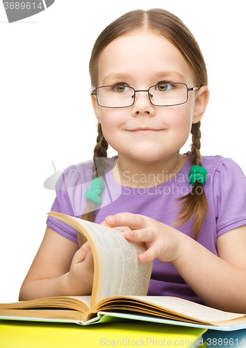 Image of Little girl is reading a book