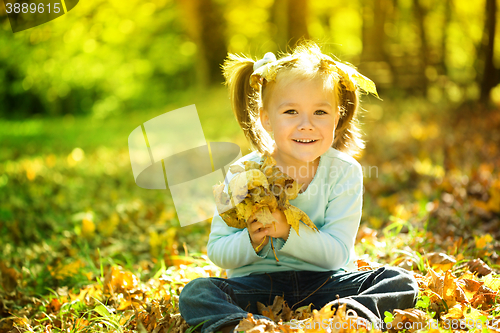 Image of Portrait of a little girl in autumn park