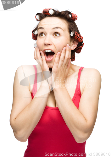 Image of Woman is holding her face in astonishment